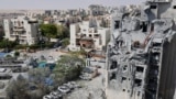 Emergency workers check the damage caused to a building from an Iranian missile strike in Beersheba in southern Israel on June 24, 2025.