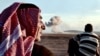 Turkey -- People watch smoke rising from the Syrian town of Ain al-Arab, known as Kobane by the Kurds, after an air strike, on October 8, 2014 in the Turkish-Syrian border, in the southeastern village of Mursitpinar, Sanliurfa province. 