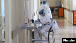 A medical worker takes notes at the Surb Grigor Lusarovich Medical Center in Yerevan, Armenia's largest hospital treating coronavirus patients, June 5, 2020.