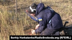 Ольга, сотрудница «The HALO Trust», проверяет поверхность грунта на наличие взрывоопасных предметов 
