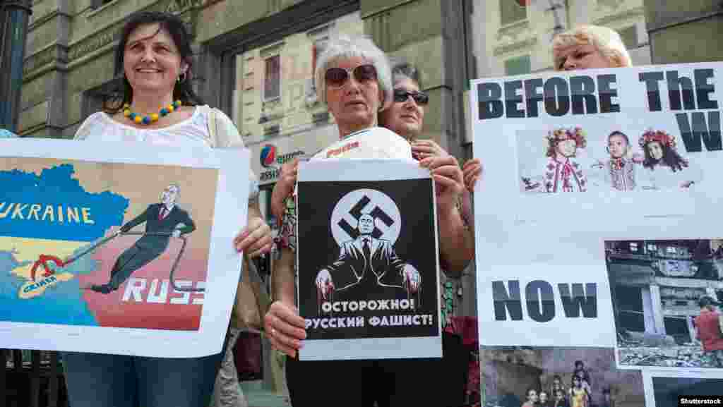 Плакати учасників протесту проти агресії Росії за день до візиту до Італії російського президента Володимира Путін. Мілан, 9 червня 2015 року