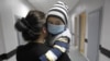 Georgia -- Nikoloz, a four-year-old leukaemia patient, is carried by her mother in the onco-hematology department of the Iashvilli Central Children's Hospital in Tbilisi, 07Apr2011