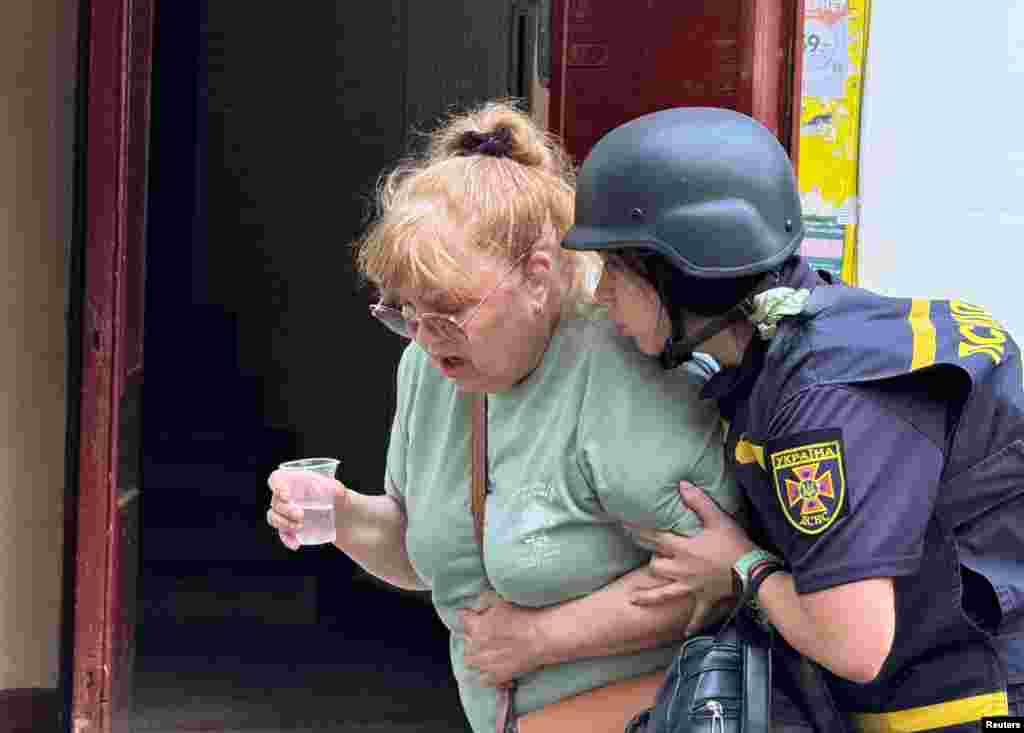 Психологиня заспокоює жінку, яка шукала свого внука. Він живий та здоровий, як повідомили кореспондентам агенції Reuters